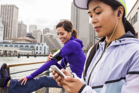 Runner using cell phone at waterfront