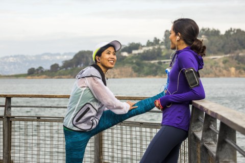 Runners stretching at waterfront