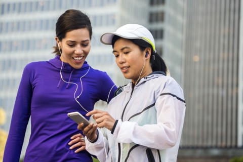 Runners using cell phone near high rise buildings