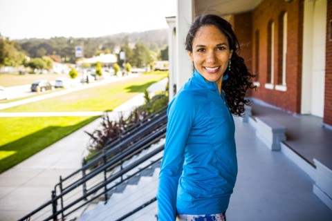 Hispanic woman smiling on patio