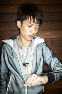 Asian man checking wristwatch