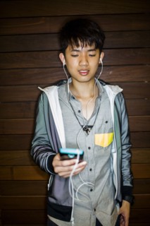 Asian man listening to music with cell phone