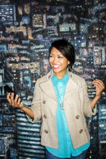 Woman listening to cell phone by mural