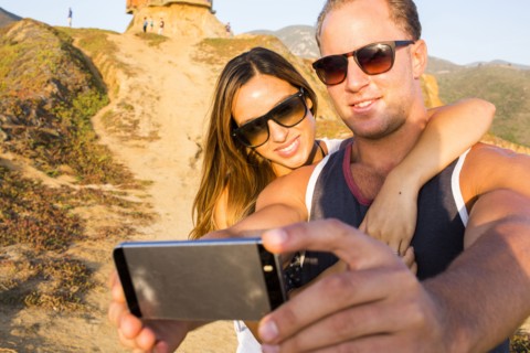 Caucasian couple taking selfie