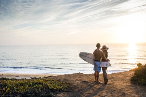 Caucasian couple admiring seascape at beach