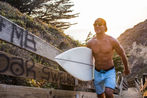 Caucasian surfer carrying surfboard