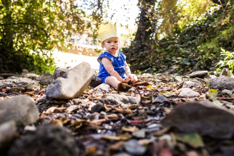Caucasian baby girl sitting in grass