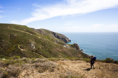 Caucasian mother and child hiking at coast