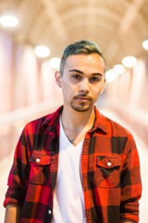 Serious Hispanic man wearing flannel shirt