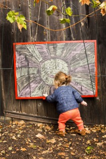 Caucasian baby girl drawing outdoors