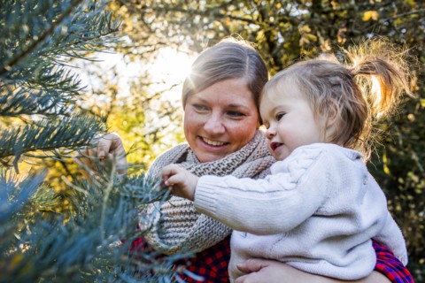 Caucasian mother and daughter admiring tree