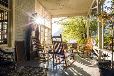 Reflection of sun on porch with rocking chairs