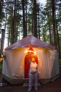 Caucasian woman waving sparkler outside yurt