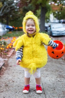 Smiling Caucasian girl wearing chicken costume on Halloween