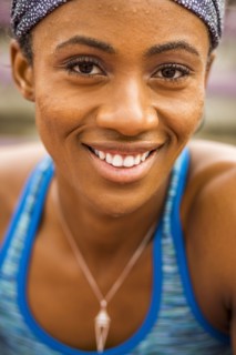 Smiling Black woman sweating