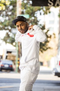 Black man adjusting hoody in city