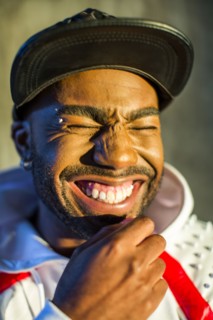 Black man laughing with eyes closed