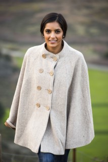 Portrait of smiling Indian woman wearing poncho