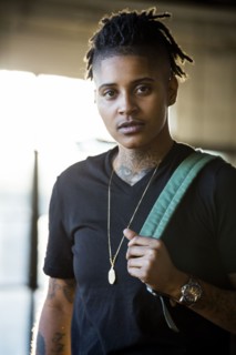 Portrait of androgynous Mixed Race woman carrying backpack