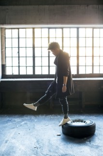 Androgynous Asian man standing on wheel