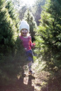 Excited Caucasian girl standing near trees