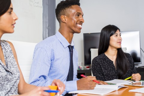 People smiling in business meeting
