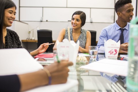 People eating with chopsticks in meeting