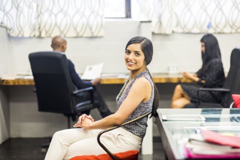 Portrait of smiling Asian woman sitting in office
