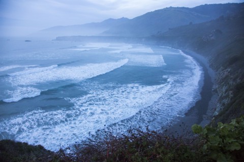 Scenic view of ocean beach and cliffs