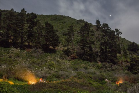 Campfire on hill at night