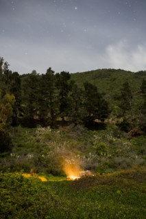 Campfire on hill at night