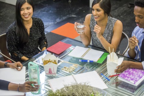 Business people eating food during meeting
