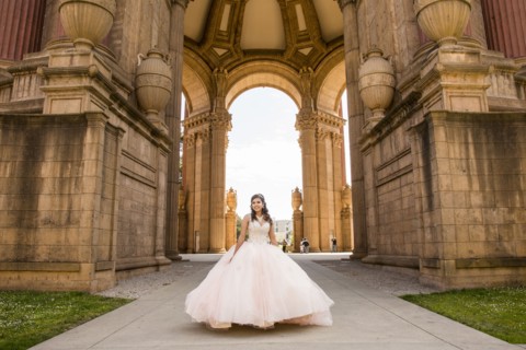Smiling Hispanic girl wearing gown