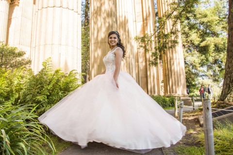 Portrait of smiling Hispanic girl wearing gown