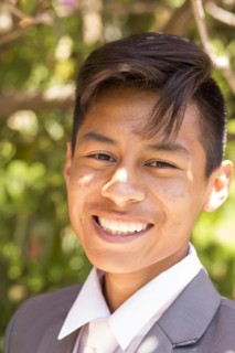 Portrait of smiling Hispanic boy wearing suit