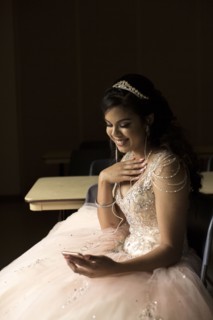 Smiling Hispanic girl listening to cell phone with earbuds
