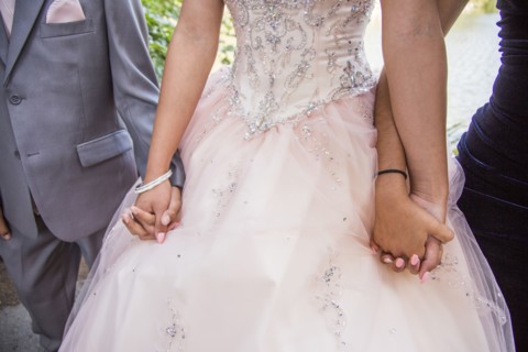 Hispanic boy and girls holding hands