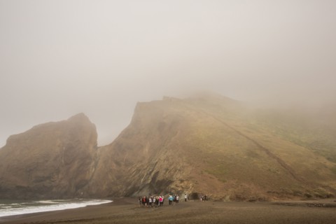 Distant crowd of people standing on beach