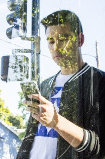 Serious Chinese man texting on cell phone behind window