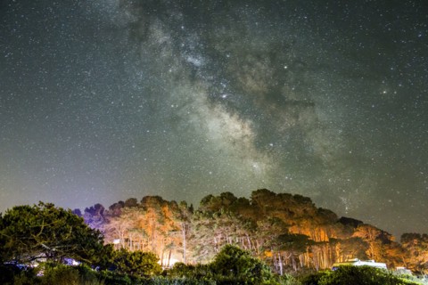 Starry night sky above mountains