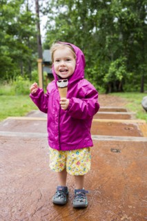 Smiling Caucasian girl eating ice cream cone