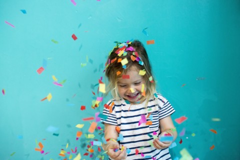 Colorful confetti falling on Caucasian girl
