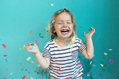 Colorful confetti falling on Caucasian girl