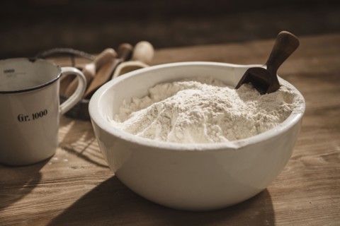 Close up of bowl of flour with scoop