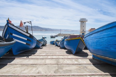 Blue boats docked on boat ramp