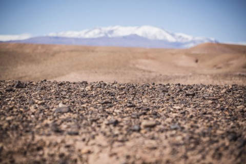 Surface level view of gravel field and remote desert