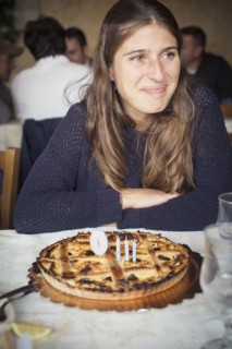 Caucasian woman with birthday cake in restaurant