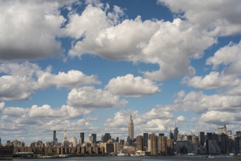 New York City skyline under cloudy blue sky