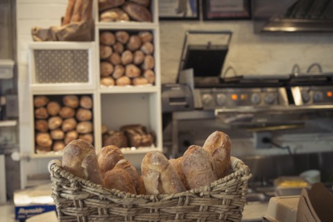 Baguettes in basket on bakery counter