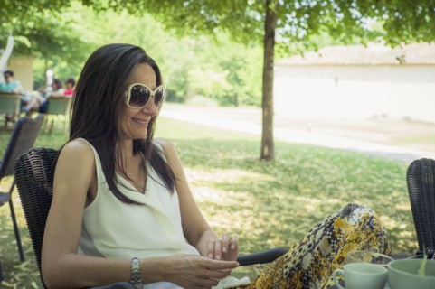Caucasian woman sitting in chair in backyard